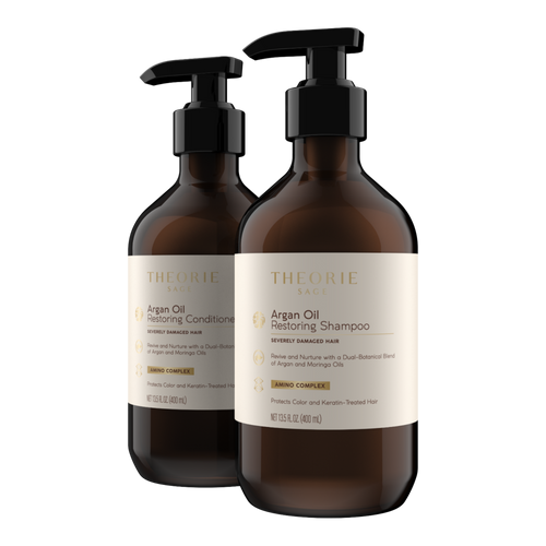 Two bottles of Theorie Argan Oil Restoring Shampoo and Conditioner on a white background